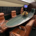 alt="table & seats inside an airplane"