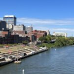 alt="a river with a row of tall buildings"