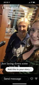 "two people pretending to record a song"