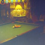 alt="snooker table with lamp over it"