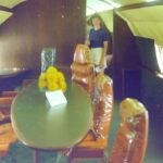 alt=" airplane table & chairs with person from different angle"