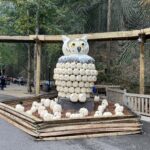 alt="owl statue made of pumpkins"