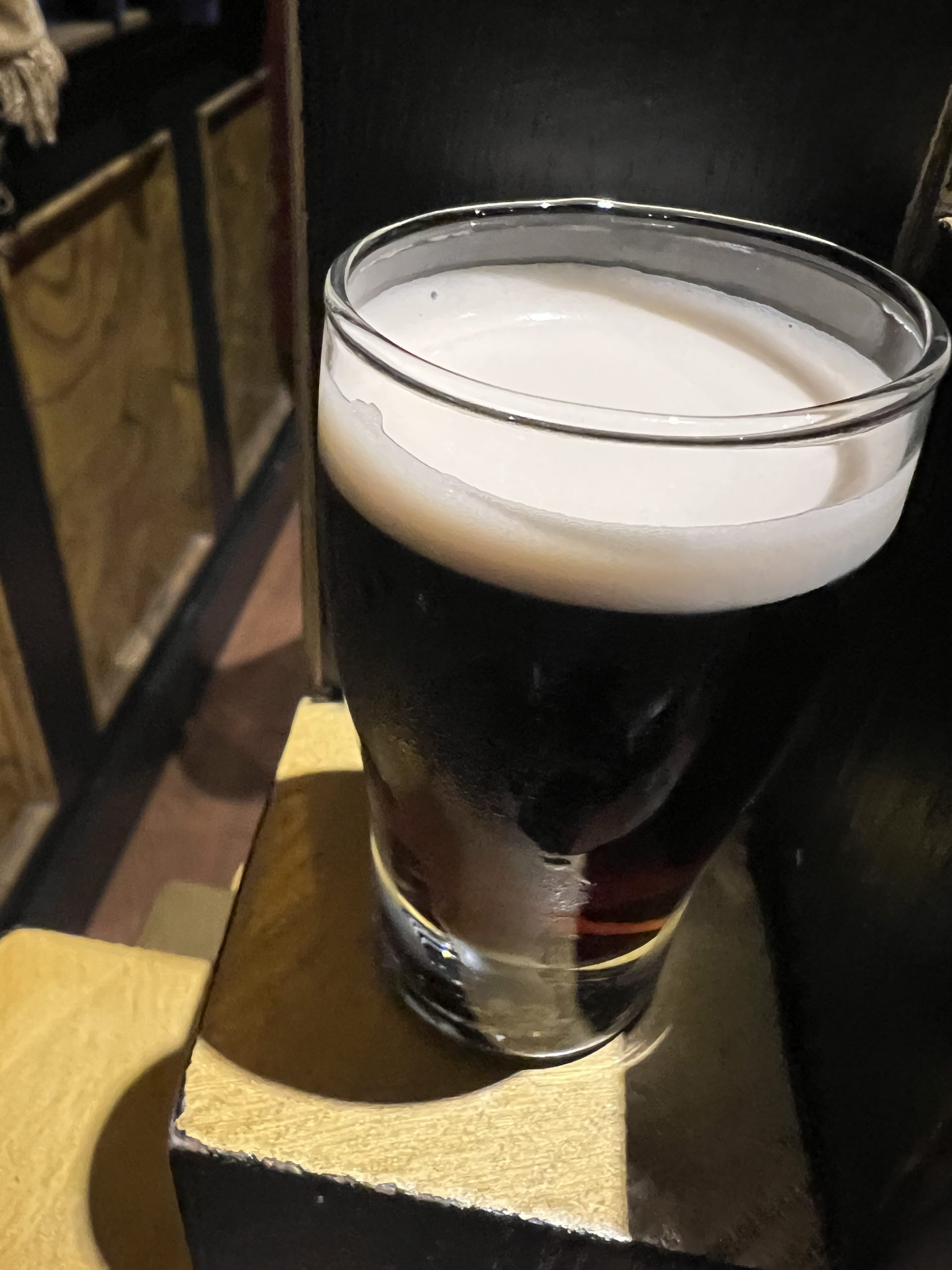 alt="a pint glass with Guinness in it"