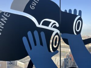 alt="hands holding glasses etched on window"