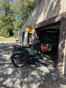 alt="old motorbikes outside shed"