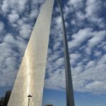 alt="shiny arch with sky & clouds"