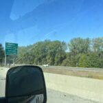 alt="road sign showing Kanas"