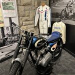 alt="motorbike with racing suits"