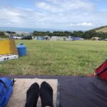 alt="pair of feet in entrance to small tent"