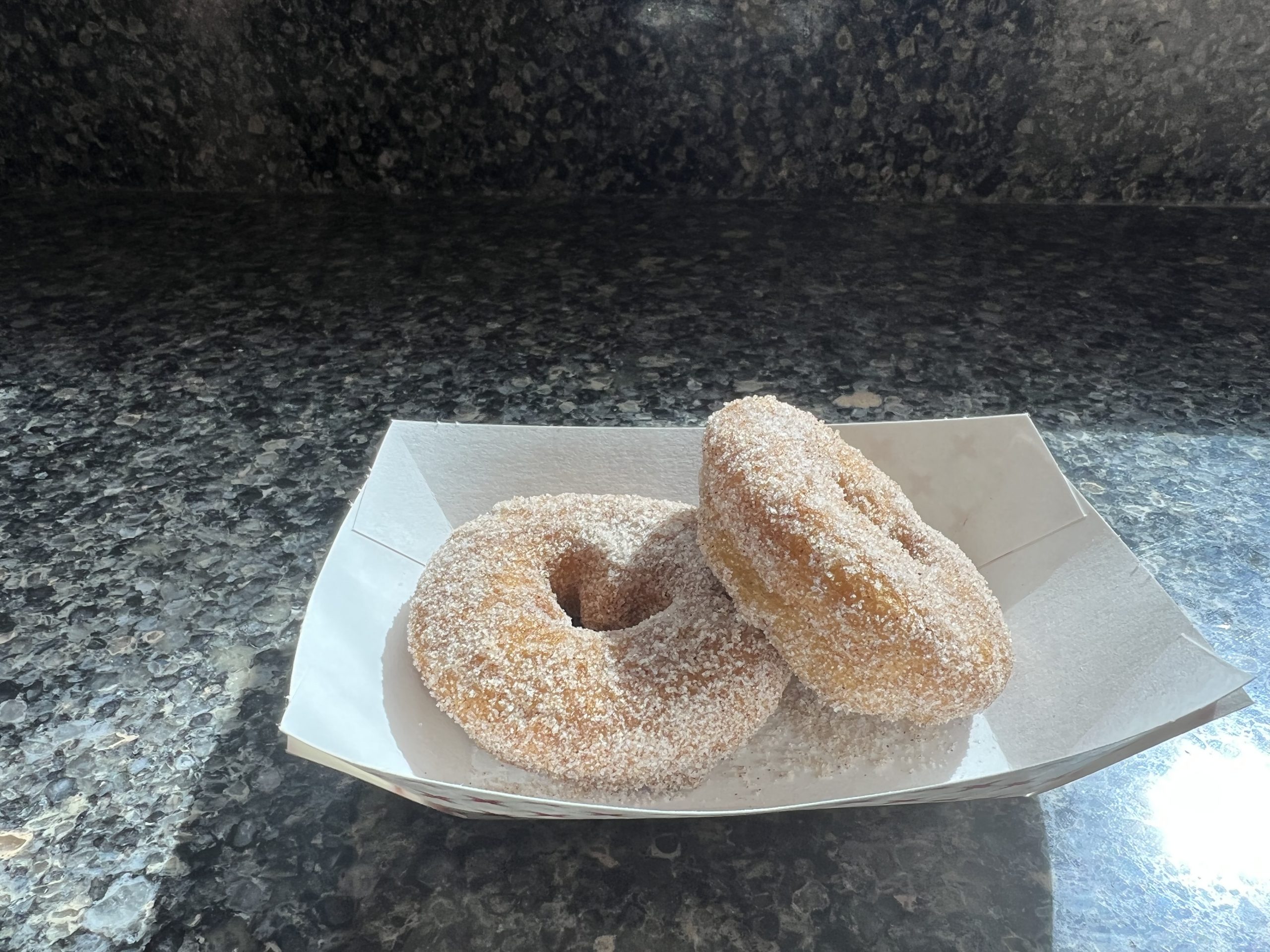 alt="two sugar coated doughnuts"