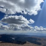 alt="valley with cloudy sky"