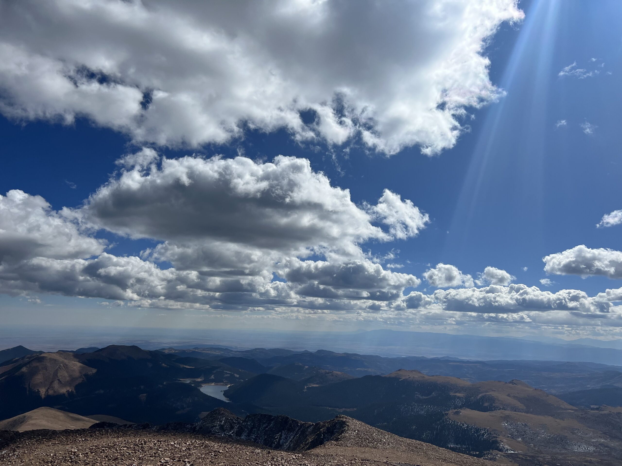 alt="valley with cloudy sky"