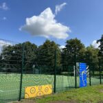 alt="fence with children's games attached"
