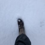 alt="leg with wellington in snow"