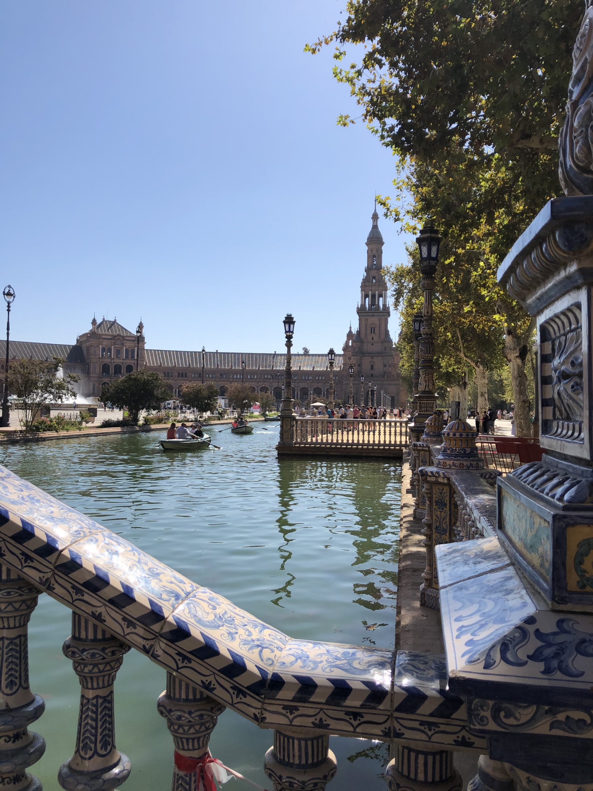 alt="gardens in Seville with boats on a lake"