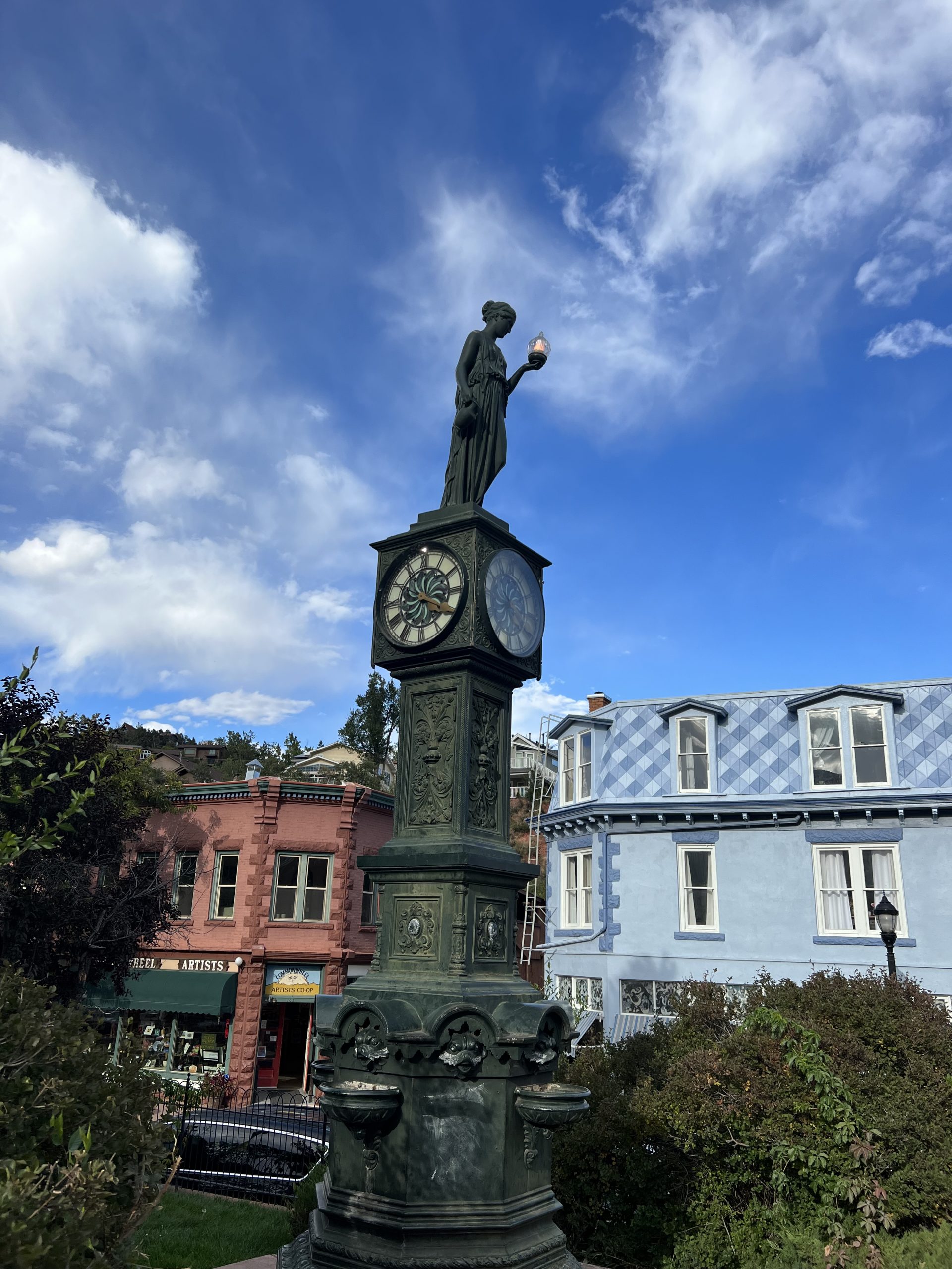 alt="clock with statue of person on top"