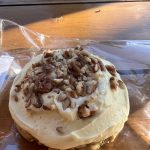 alt="doughnut with cream cheese & nut topping"