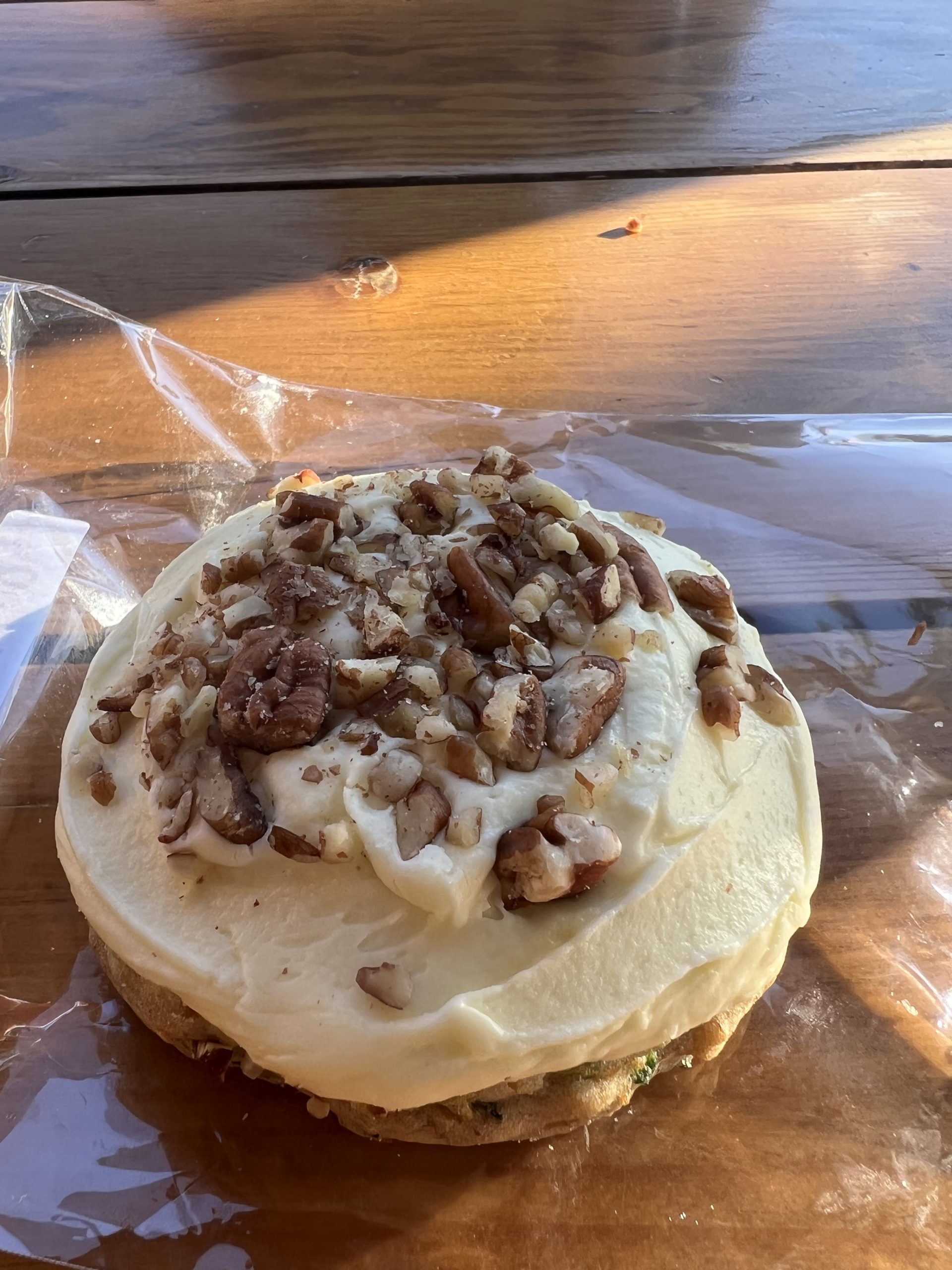 alt="doughnut with cream cheese & nut topping"