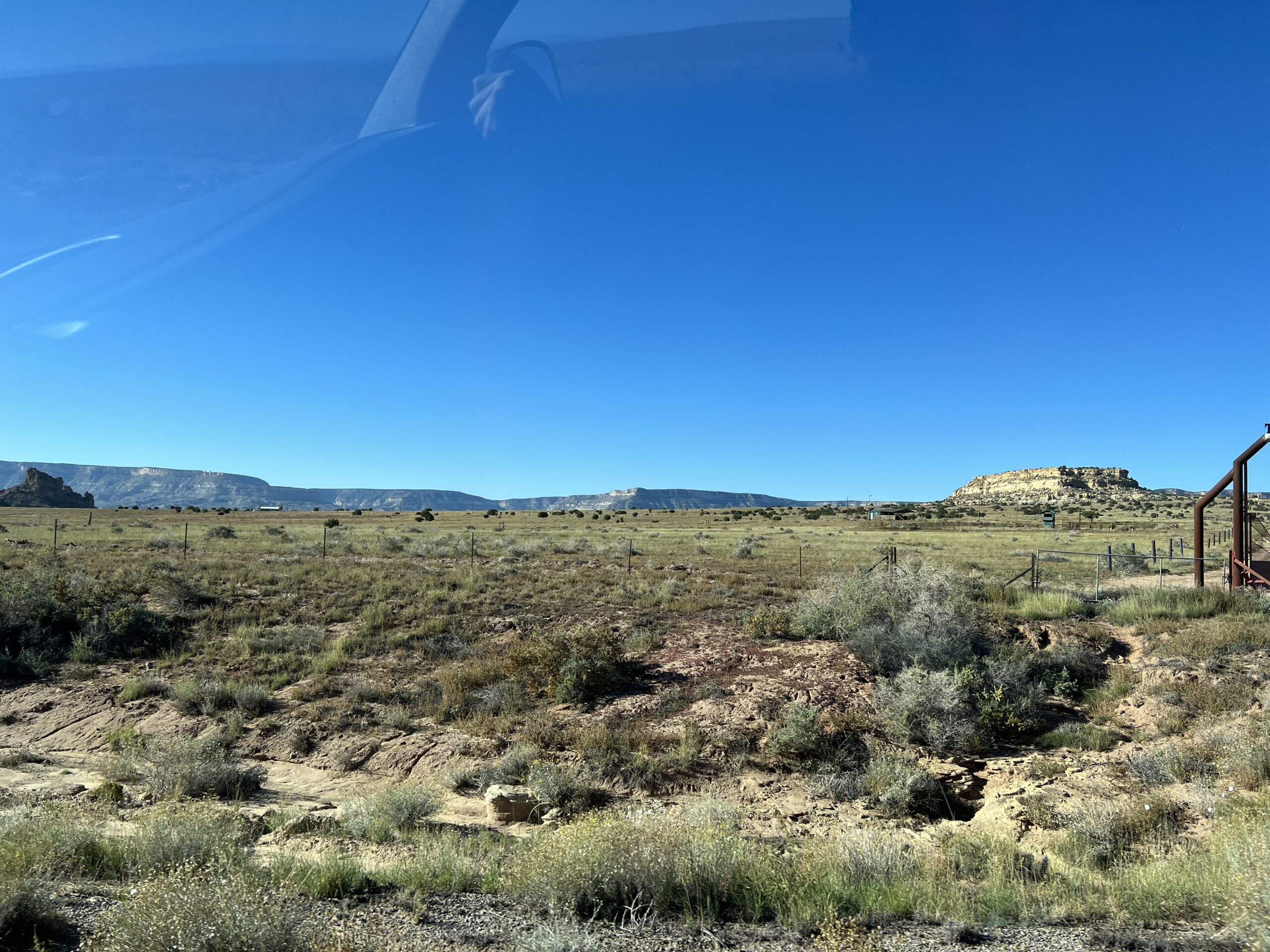 scrub land with rock outcrops in distance