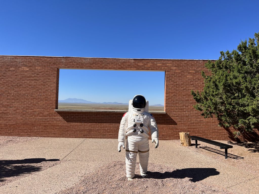 alt="figure in space suit"