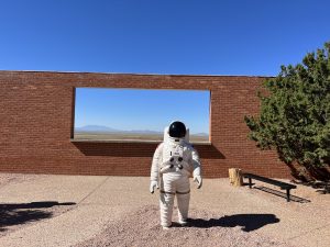 alt="figure in space suit"