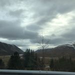 alt="scenery from the car window of lakes & mountains"