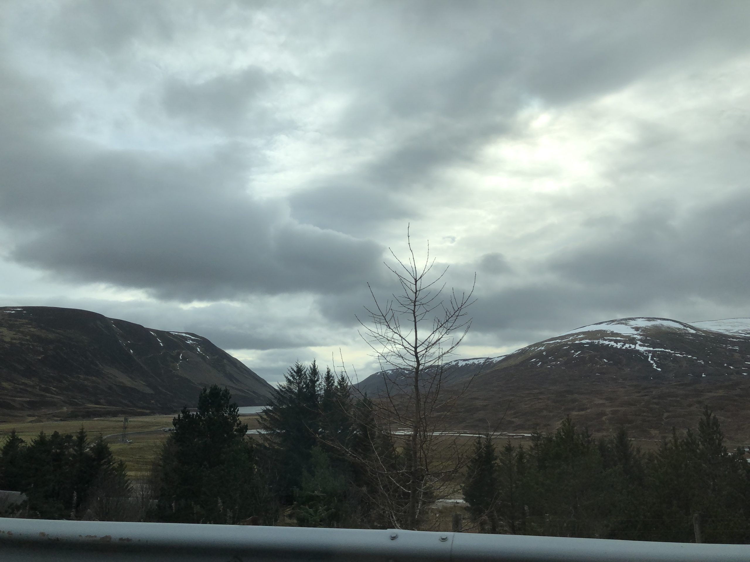 alt="scenery from the car window of lakes & mountains"
