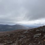 alt="glimpse of the surrounding mountain view as fog lifts"