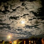 alt="strange cloud formation around the moon"