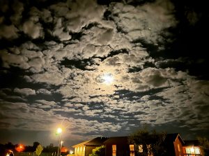 alt="strange cloud formation around the moon"