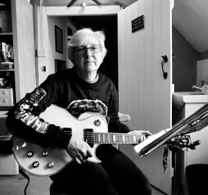 alt="me playing a guitar"
