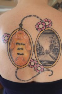 Alt="image of my tattoo with a locket & flowers"