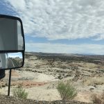 alt="barren looking landscape with blur sky & clouds"