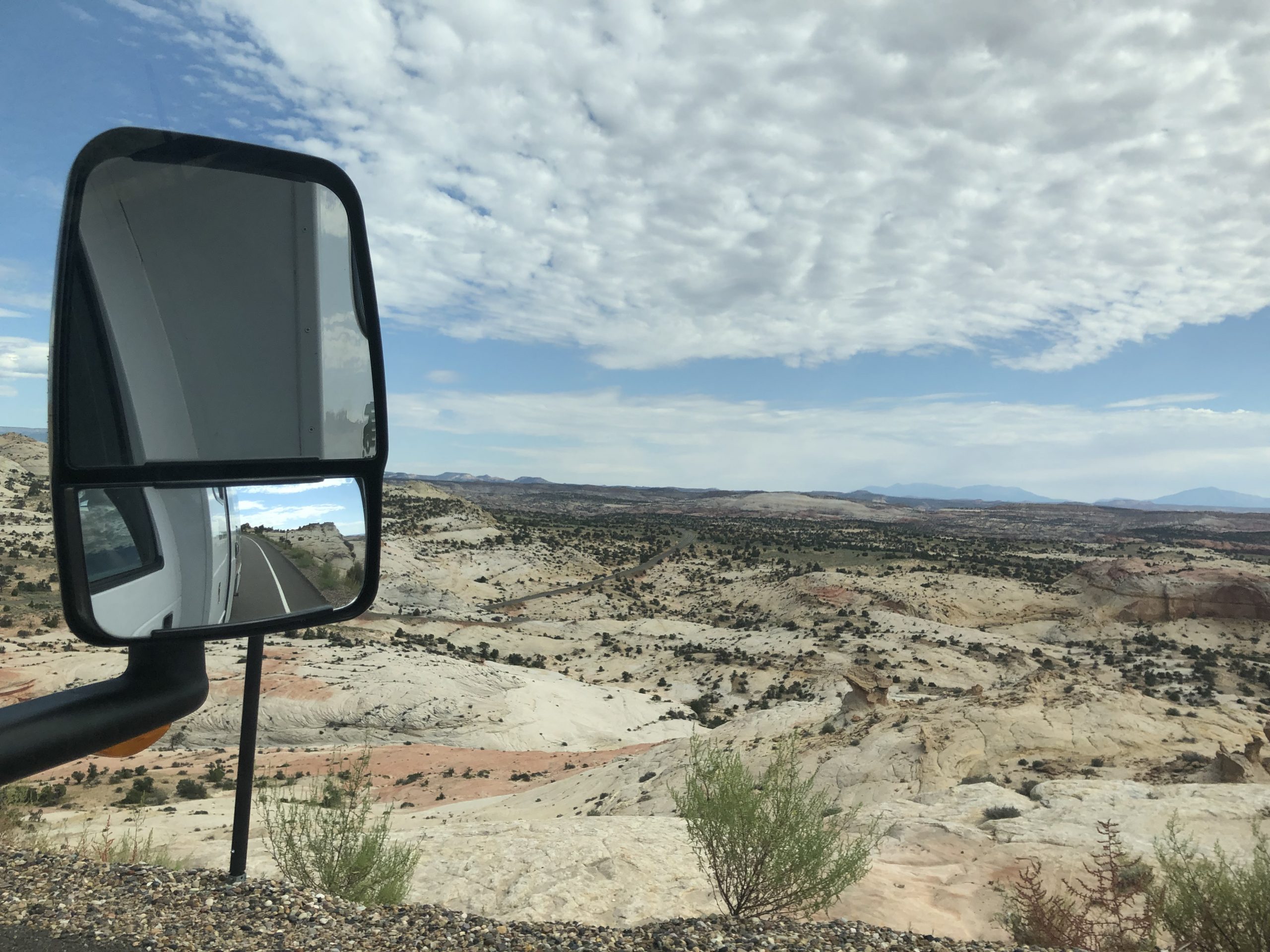 alt="barren looking landscape with blur sky & clouds"