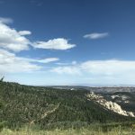 alt="sky & clouds with trees & rocks"