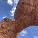 alt="underneath a big arch of rock"