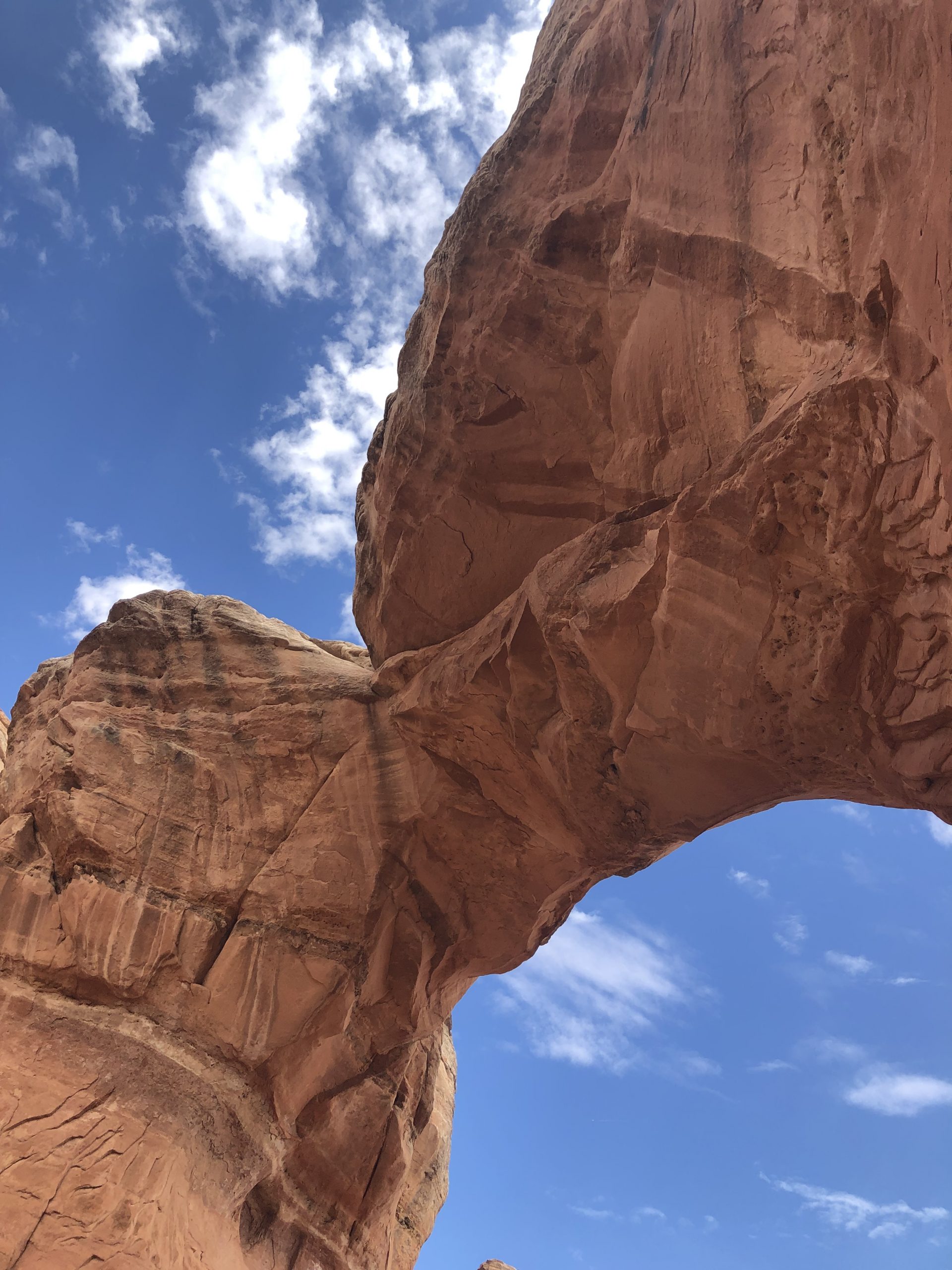 alt="underneath a big arch of rock"