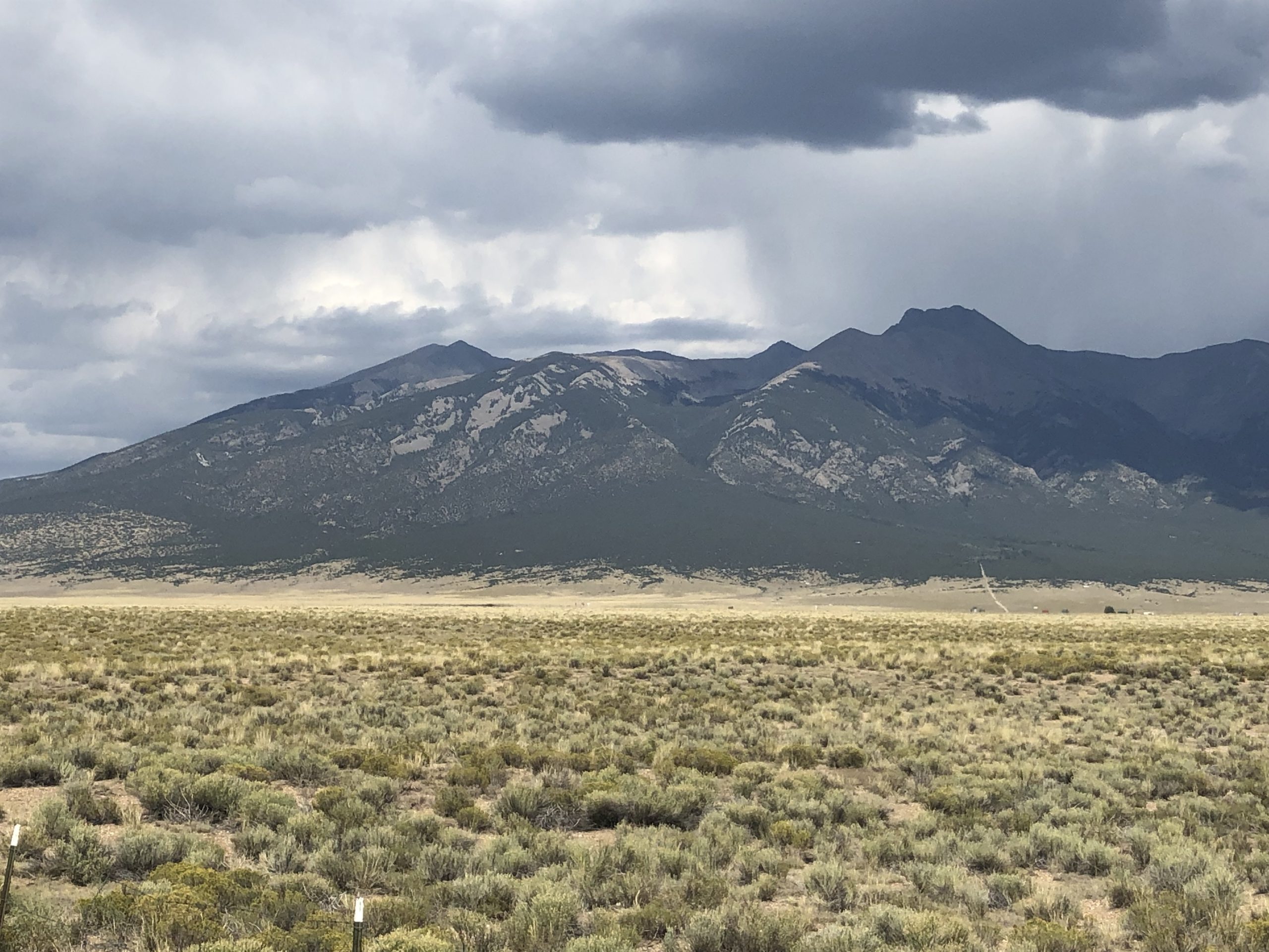 alt="stormy clouds over dry scrubland"