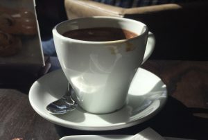 alt="cup of coffee in a china cup & saucer"