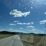 alt="open road with sky & clouds"