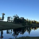 alt="a lake with trees on the side as the sunset"