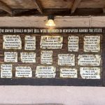 alt="various plaques commemorating those buried in the Boot Hill cemetery"