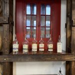 alt="distillery in dodge city with line of bottles"