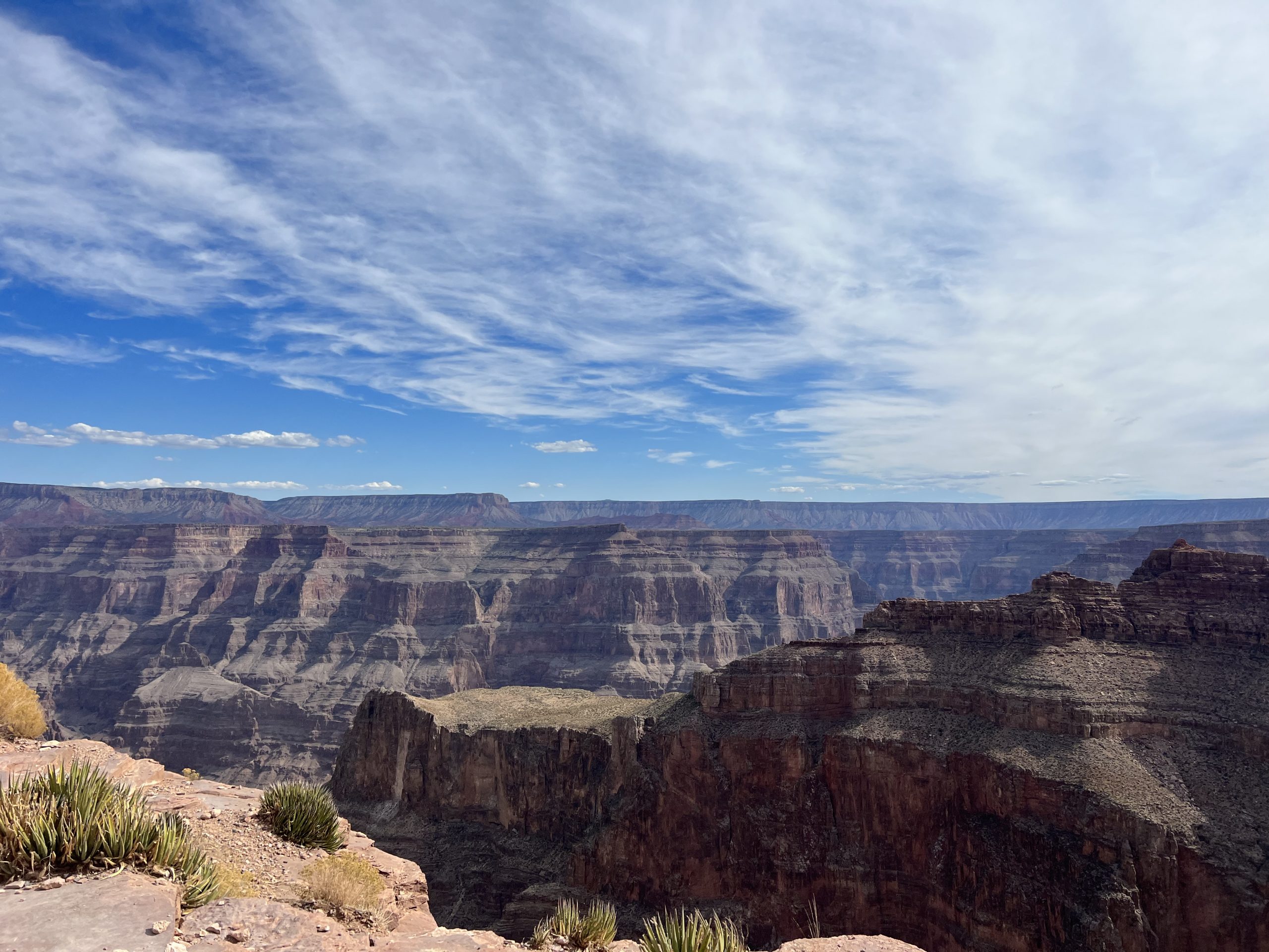 alt=" overlooking the edge at Grand Canyon with rock strata in lines"