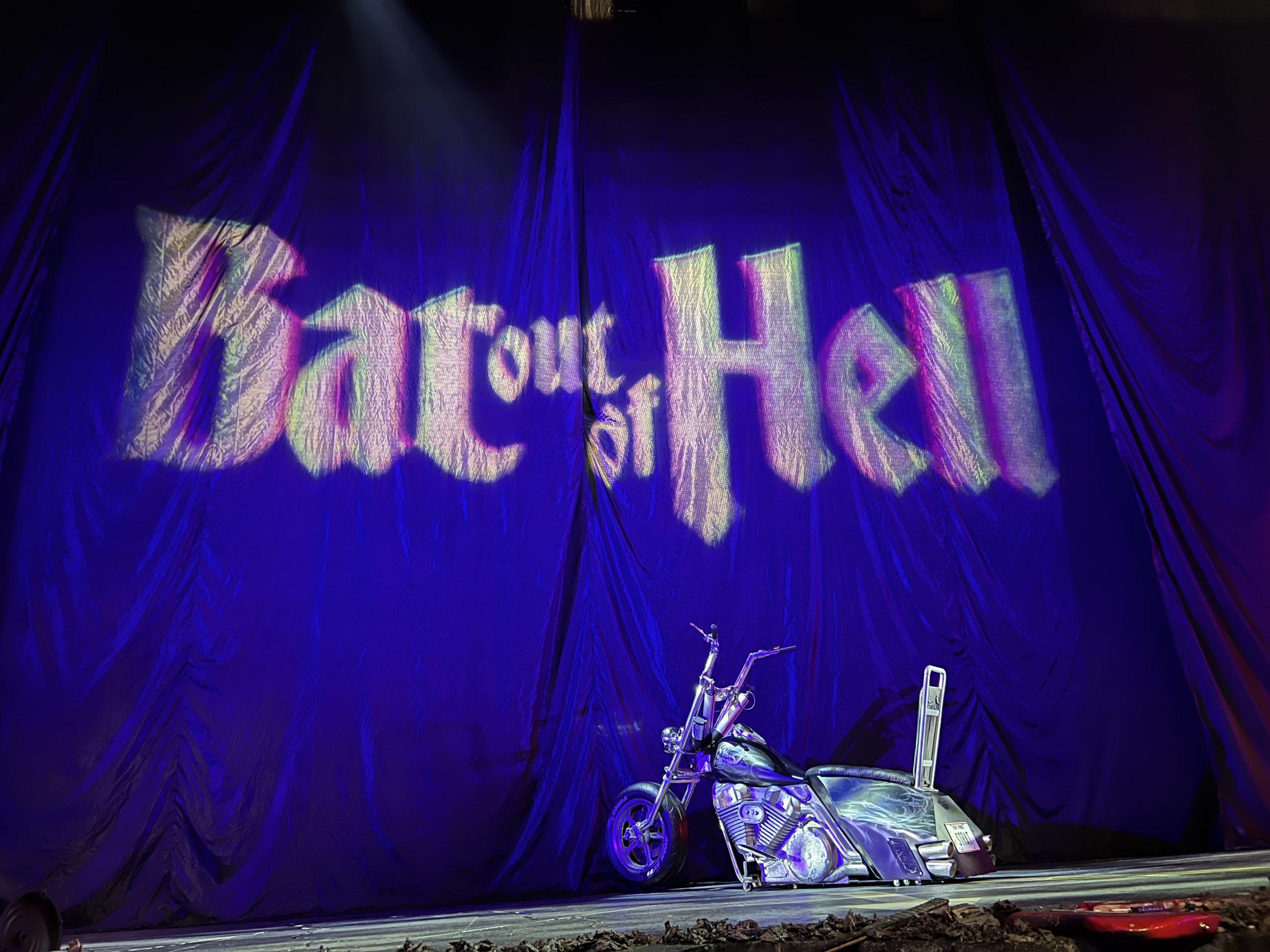 alt="curtains & motorbike from set of the Meatloaf musical "