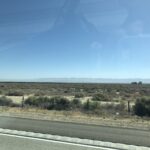 alt="scrub land & hills in distance"