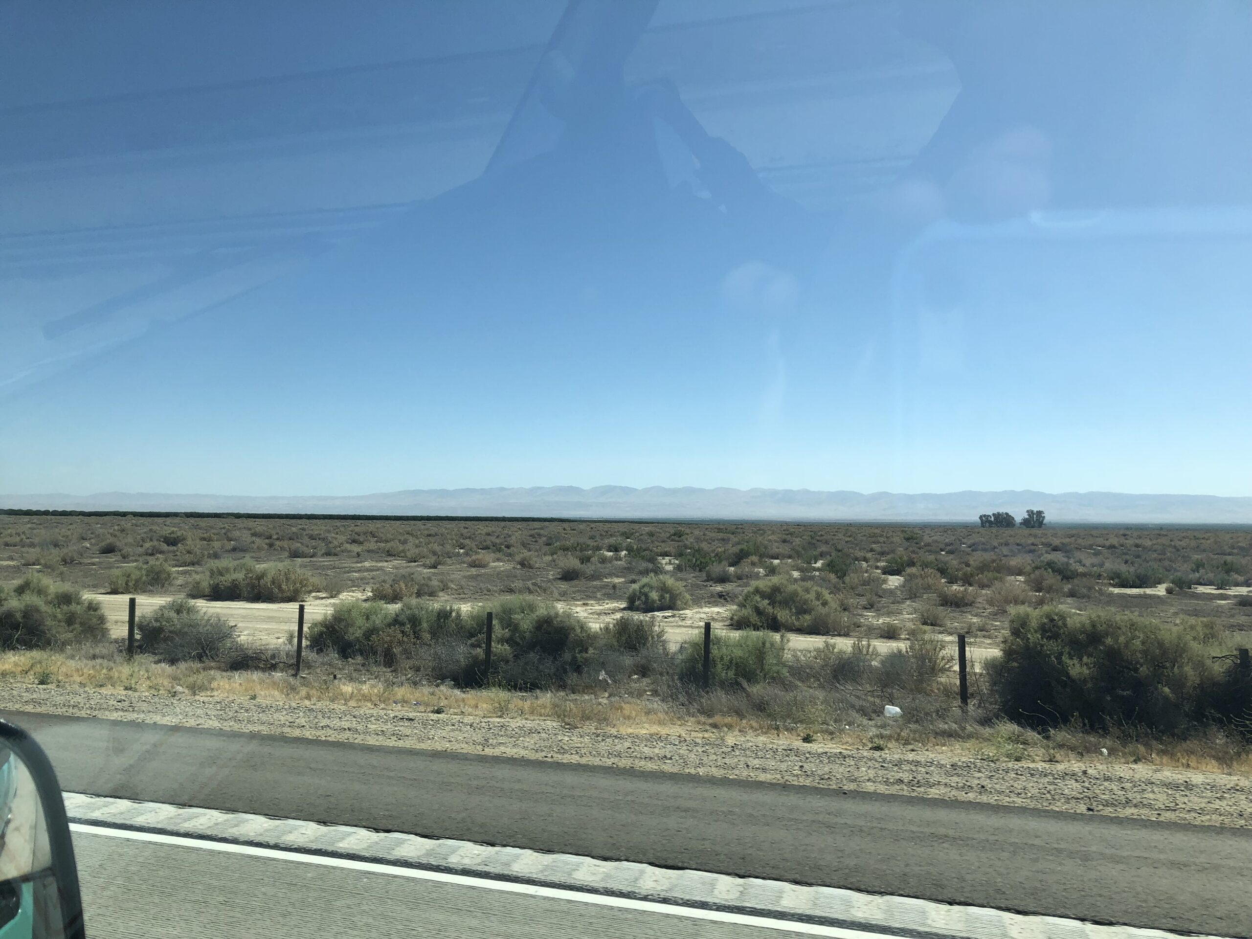 alt="scrub land & hills in distance"