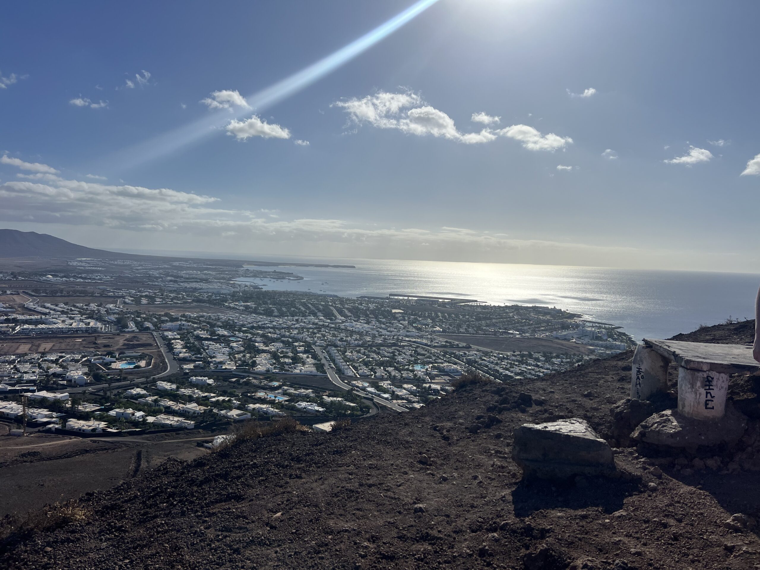 alt="view over the sea & town from the edge of the volcanic crater"