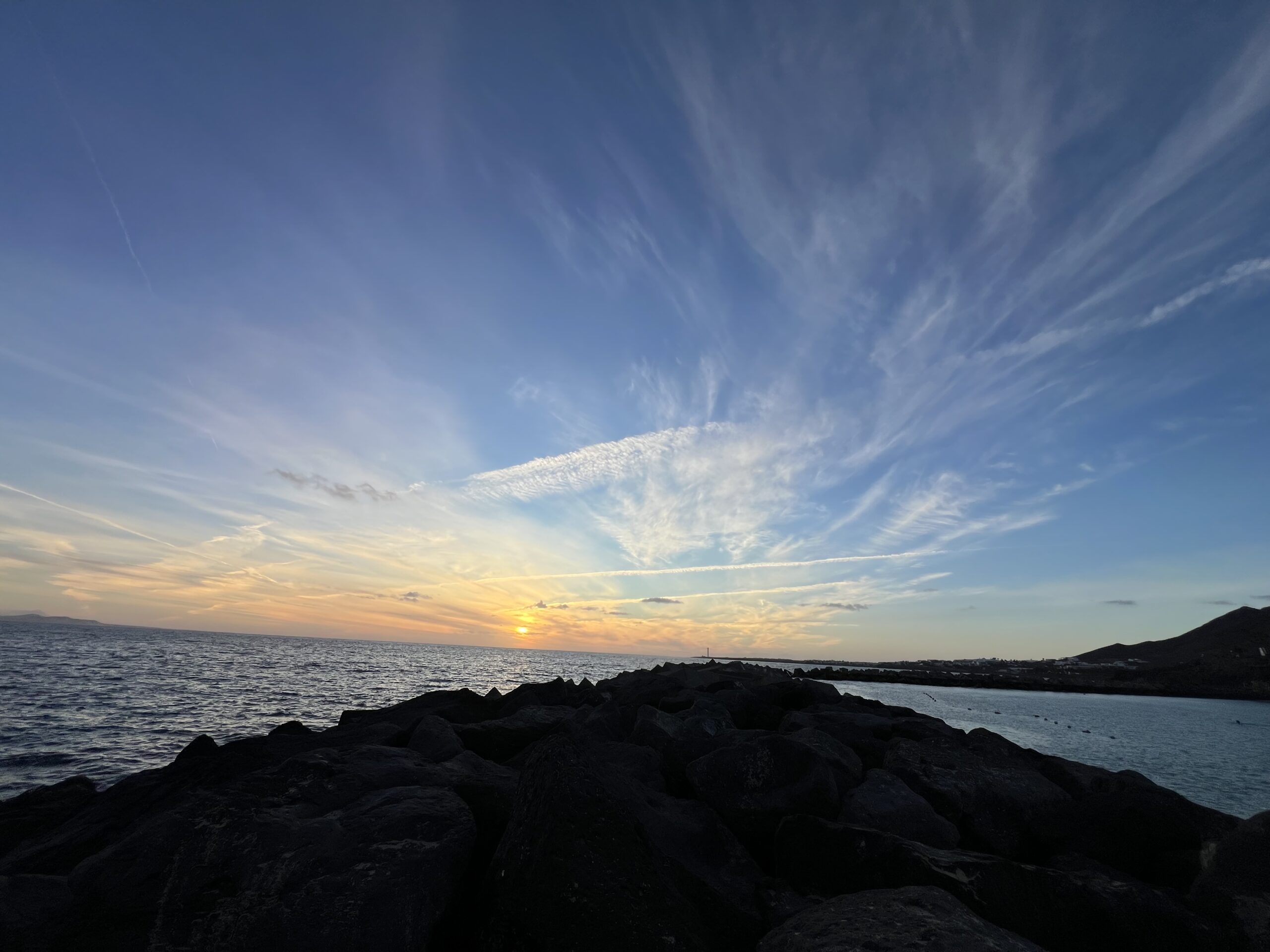 alt="a sunset over the calm sea"