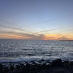 alt="sunset as seen from the seashore"